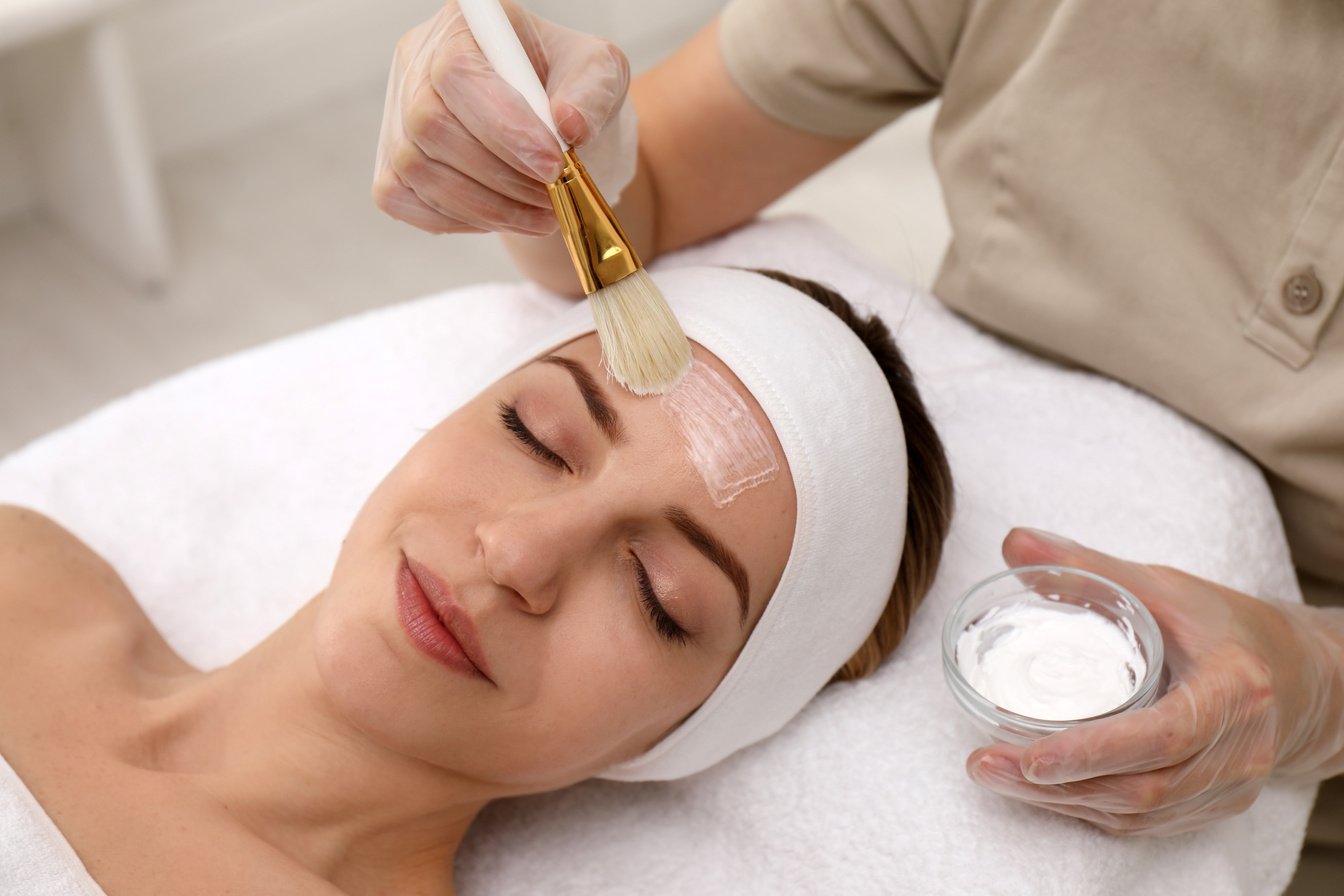 Young Woman during Face Peeling Procedure in Salon